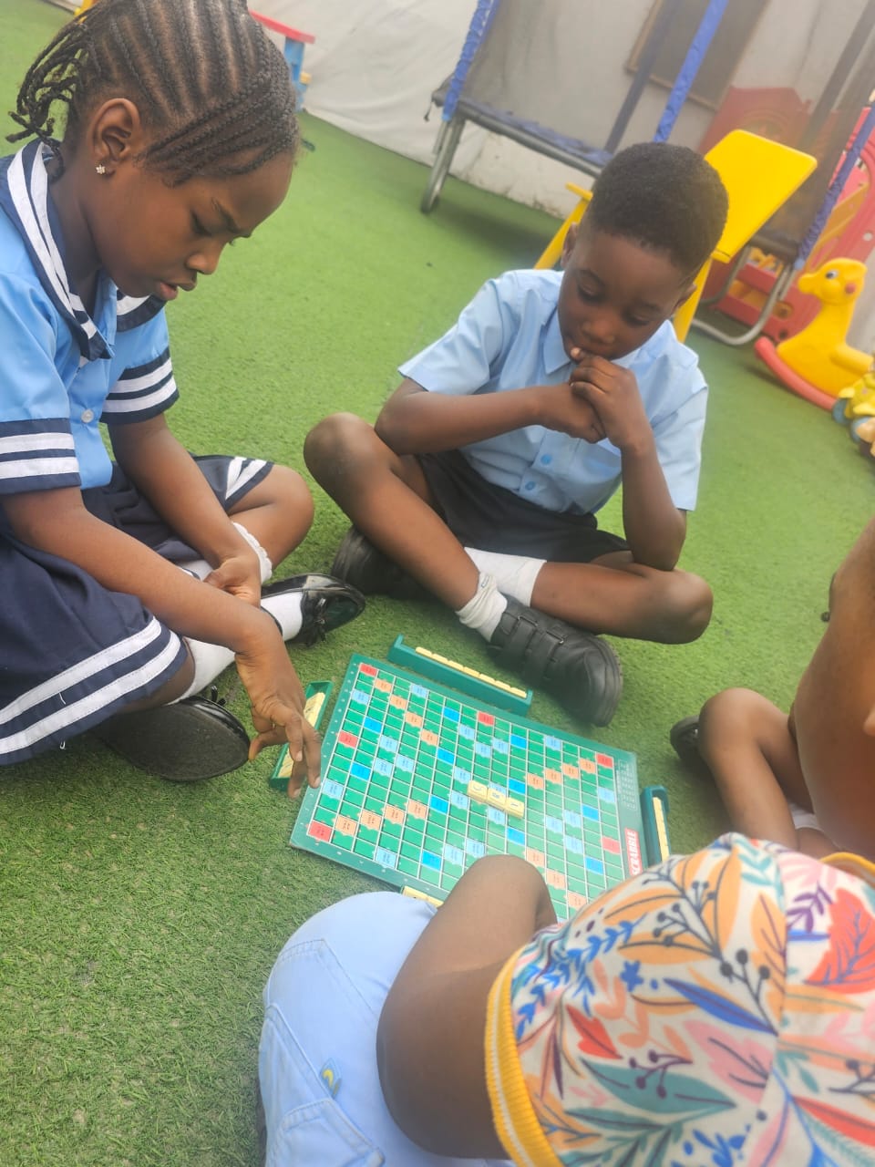 Children playing board games outdoors